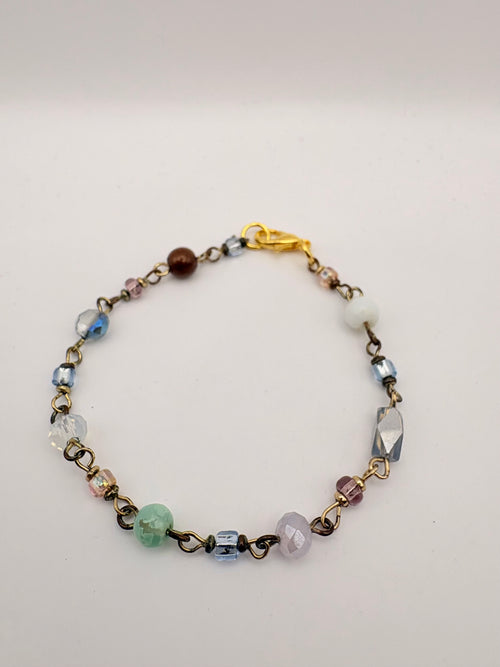 Close view of delicate chain bracelet with green bead